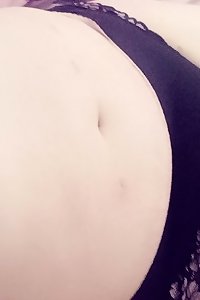 round damsel stands seductively, wearing magnificent underwear